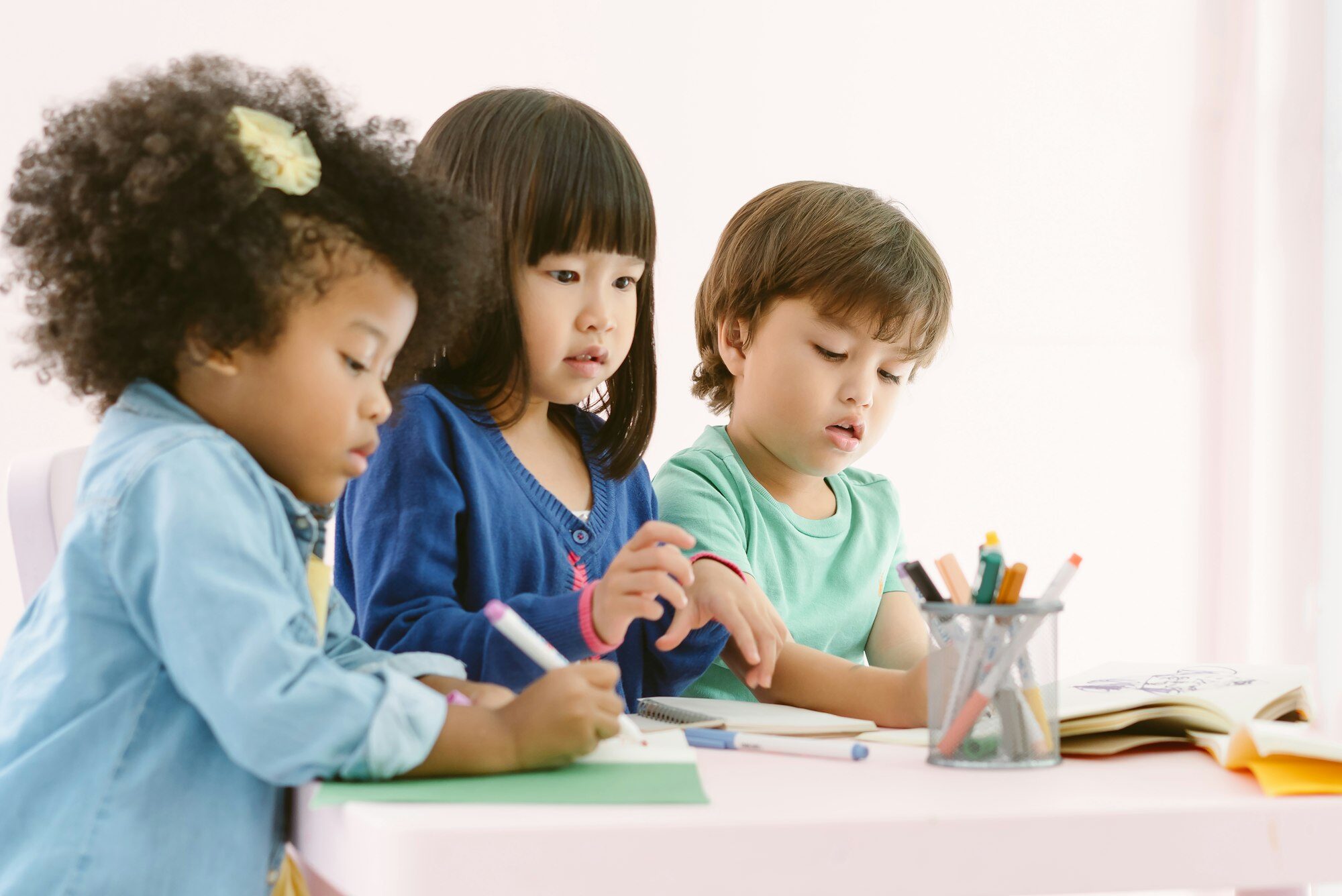 Group of diversity kids drawing and painting with crayon together with fun in art class