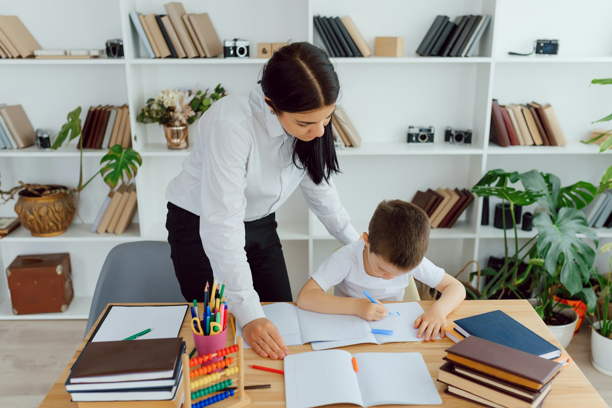 Tutor with pupil. Little girl studying. Private lesson.